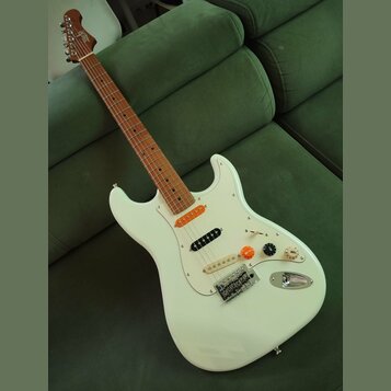 Bílá elektrická kytara s hnědým hmatníkem a bílým pickguardem. Na hlavě je viditelné logo "Squier". Nástroj má tři snímače, tři ovládací knoflíky a p…