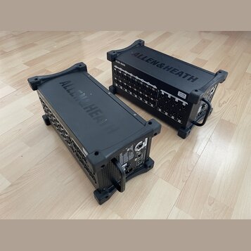 Dvě černé rackové jednotky značky ALLEN&HEATH umístěné na dřevěné podlaze. Jednotka vpravo nese nápis DX168 MixerExpand. Obě zařízení mají na horní s…