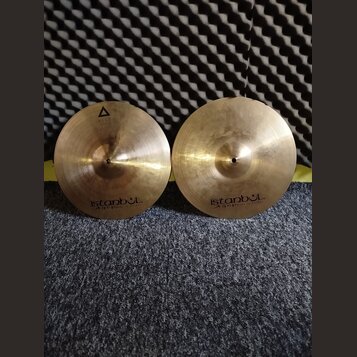 Dvě mosazné činely s viditelným opracováním povrchu. Oba mají v dolní části nápis istanbul Agop Made in Turkey. Levý činel má navíc v horní části tro…
