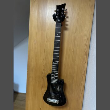 Černá elektrická kytara s lesklým povrchem a tmavým hmatníkem. Na hlavě i na těle je bílý nápis "Bafadar". Nástroj má jeden humbucker, dva potenciome…
