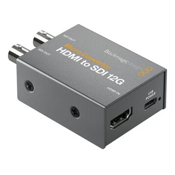 Šedý kovový konvertor s nápisy Micro Converter, HDMI to SDI 12G a Blackmagicdesign. Zařízení má dva výstupy označené jako SDI OUT, jeden vstup HDMI I…