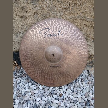 Kovový činel s kovaným povrchem a viditelnými kladivy. V horní části je nápis "Paiste" stylizovaným písmem a v dolní části text "Dimensions 20" Crash…