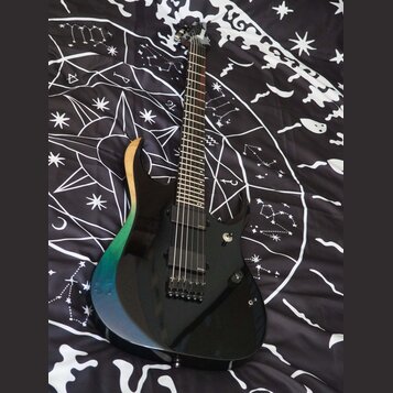 Elektrická kytara s černým bodies, které má na horním vyřezu přechod barev od dřevěné přes zelenou až po modrou. Nástroj má dva humbuckery, jeden ovl…