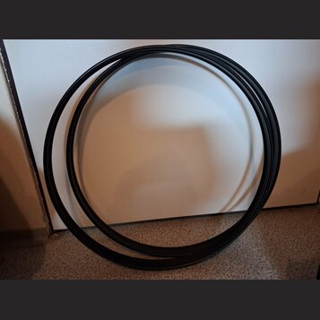 Na fotografii je černý, svinutý kabel. Povrch kabelu je hladký a matný. Žádné značky, loga ani nápisy nejsou viditelné.