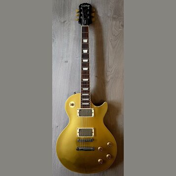Zlatá elektrická kytara typu Les Paul s tmavým hnedým hmatníkem a bílými trapezoidními vložkami. Na hlavě je bílý nápis Epiphone a podpis L. Les Paul…