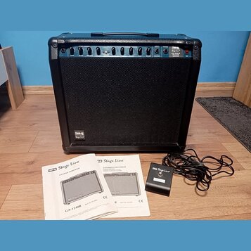 Černý kytarový kombozesilovač s látkovým předním krytem a ovládacím panelem v horní části. Na panelu jsou nápisy Stage Line, GA-1240R PRO GUITAR AMPL…
