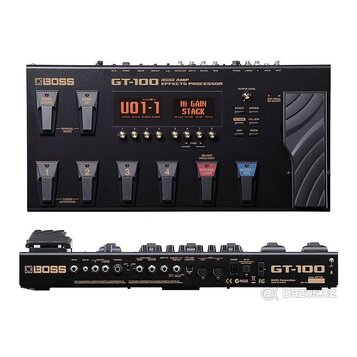 Fotografie zobrazuje efektový procesor Boss GT-100 v černé barvě. Na horní straně je nápis BOSS GT-100 AMP EFFECTS PROCESSOR, displej s textem U01-1…