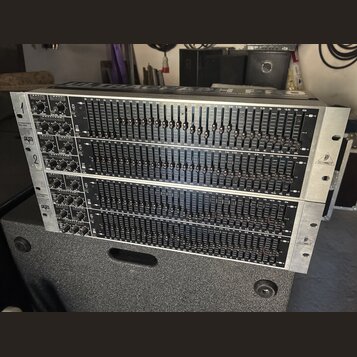 Dvě stříbrné rackové jednotky s grafickými ekvalizéry. Na obou zařízeních je v horní části nápis ULTRAGRAPH GEQ a v levé části označení FBQ. Na pravé…