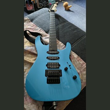 Modře lakovaná elektrická kytara s černým hardwarem a třemi snímači. Na každém ze snímačů je bílý nápis Seymour Duncan. Na hlavě hmatníku je viditeln…