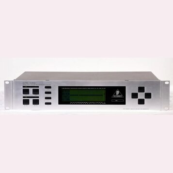 Stříbrný rackový procesor s nápisem ULTRA-CURVE® DIGITAL 24-BIT DUAL DSP MAINFRAME MODEL DSP 6000. Uprostřed je umístěn zelený LCD displej s grafický…