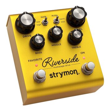 Zlatý kytarový efekt s nápisy Riverside multistage drive a strymon. Na horní straně jsou čtyři černé otočné knoflíky s označením DRIVE, BASS, MIDDLE…