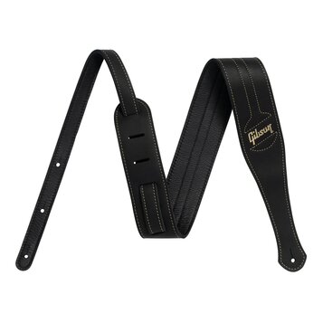 Černý kožený popruh na hudební nástroj s bílým prošíváním po okrajích. Na pravém konci je zlatým nápisem vyrazeno logo Gibson. Popruh má v jedné část…