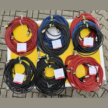 Šest svátků audio kabelů v červené, modré a černé barvě s XLR konektory. Na kabelech jsou bílé cenovky s nápisy: „13 m 400,-“, „11 m 350,-“, „8 m 300…